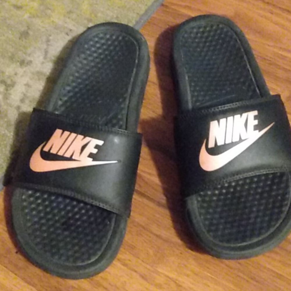 Pink and black nike slides